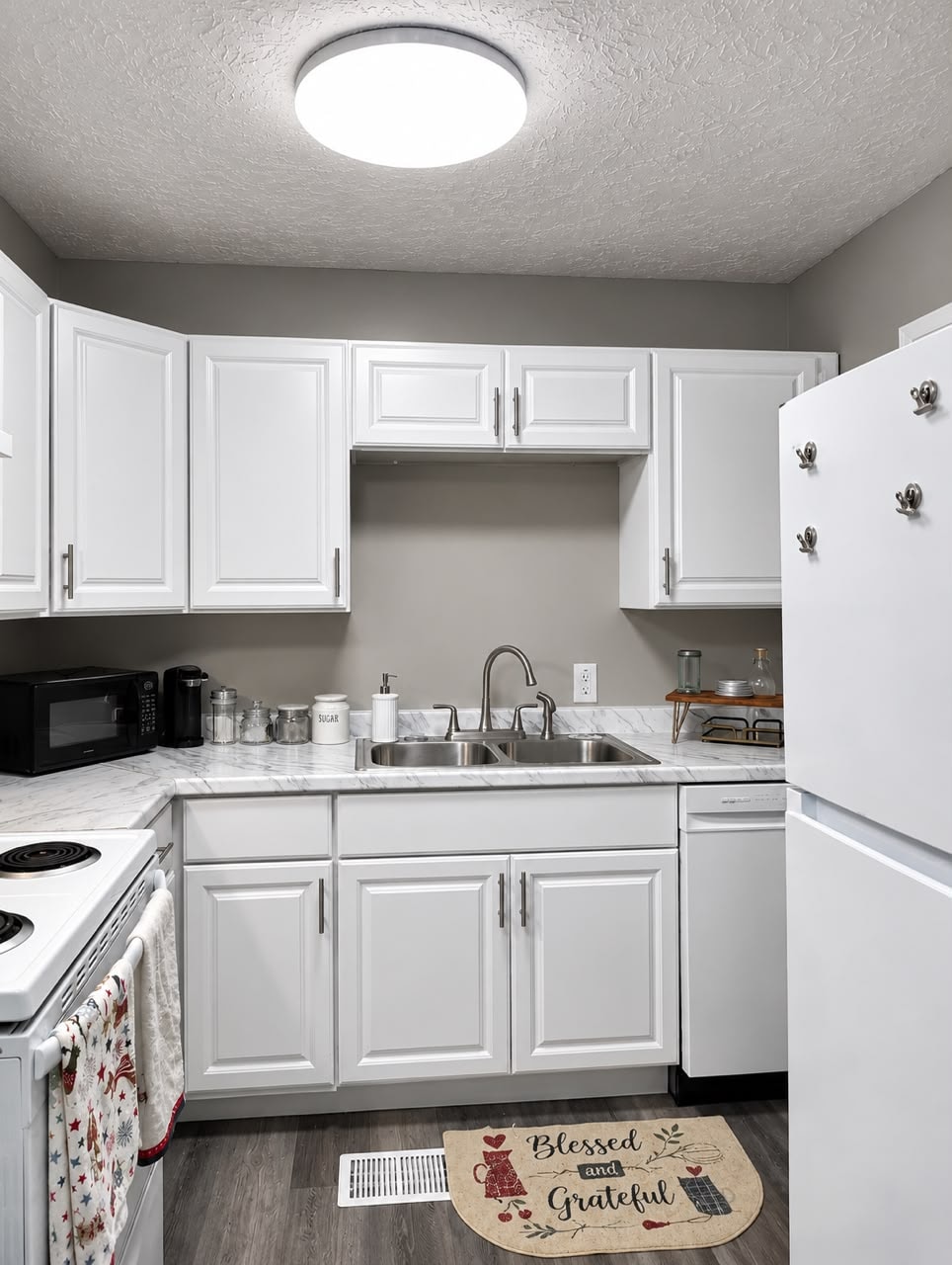 Modern kitchen with white cabinets and marble countertops